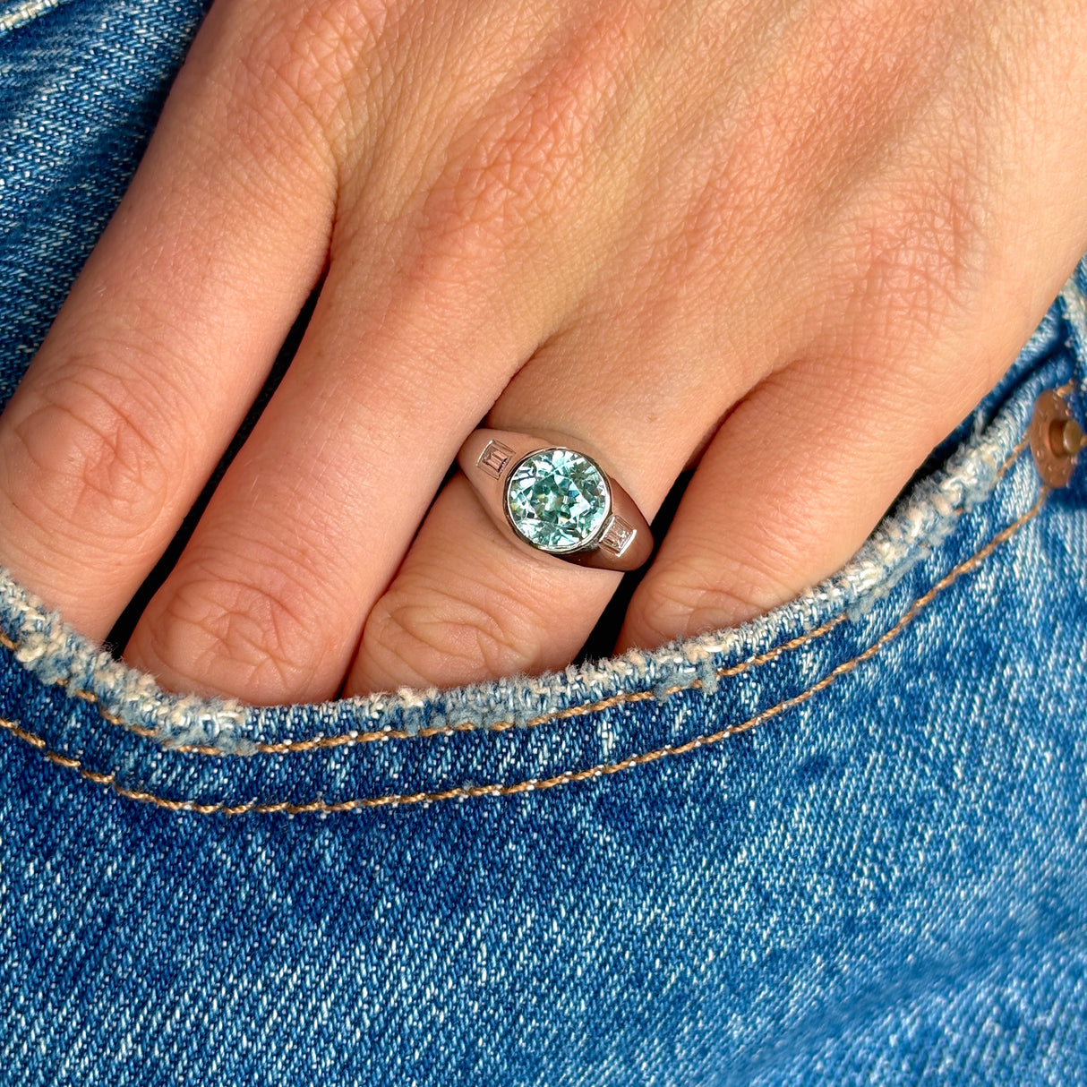 Vintage rub-over zircon & diamond ring on hand.