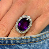 Antique, vintage amethyst & diamond cluster ring worn on hand.