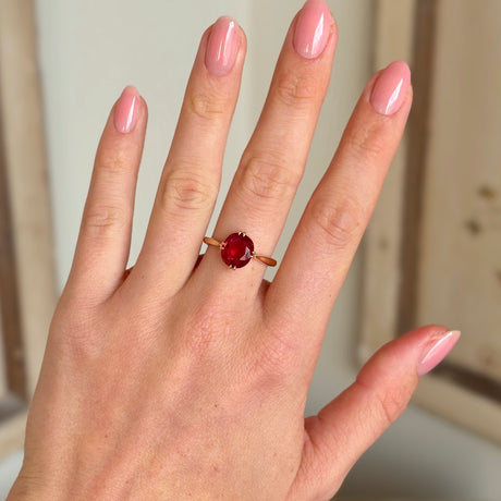 Antique, Edwardian red spinel single-stone ring worn on hand.