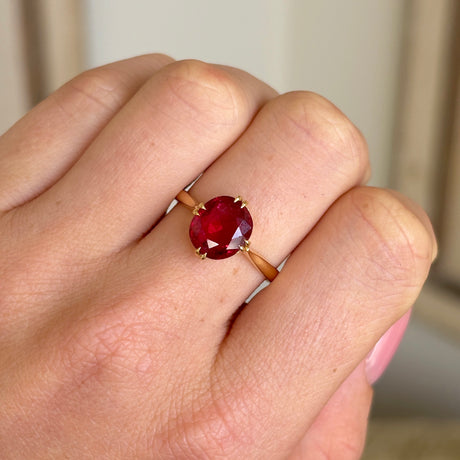 Antique, Edwardian red spinel single-stone ring worn on hand.