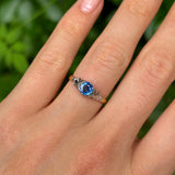 Vintage, 1960s single-stone sapphire ring worn on hand.