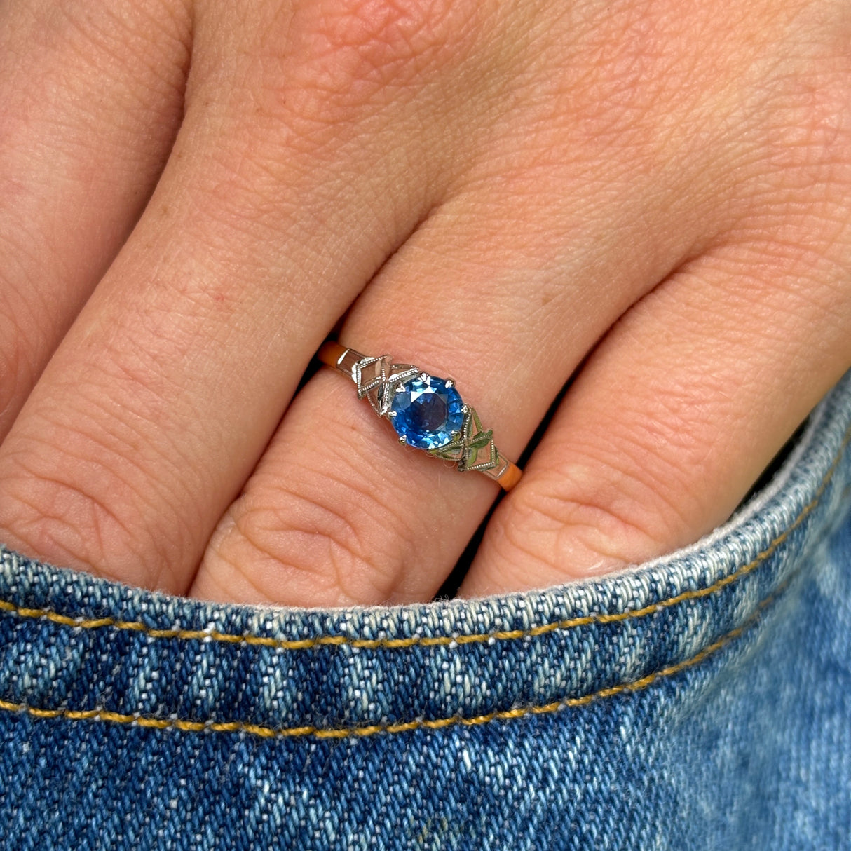 Vintage, 1960s single-stone sapphire ring worn on hand.