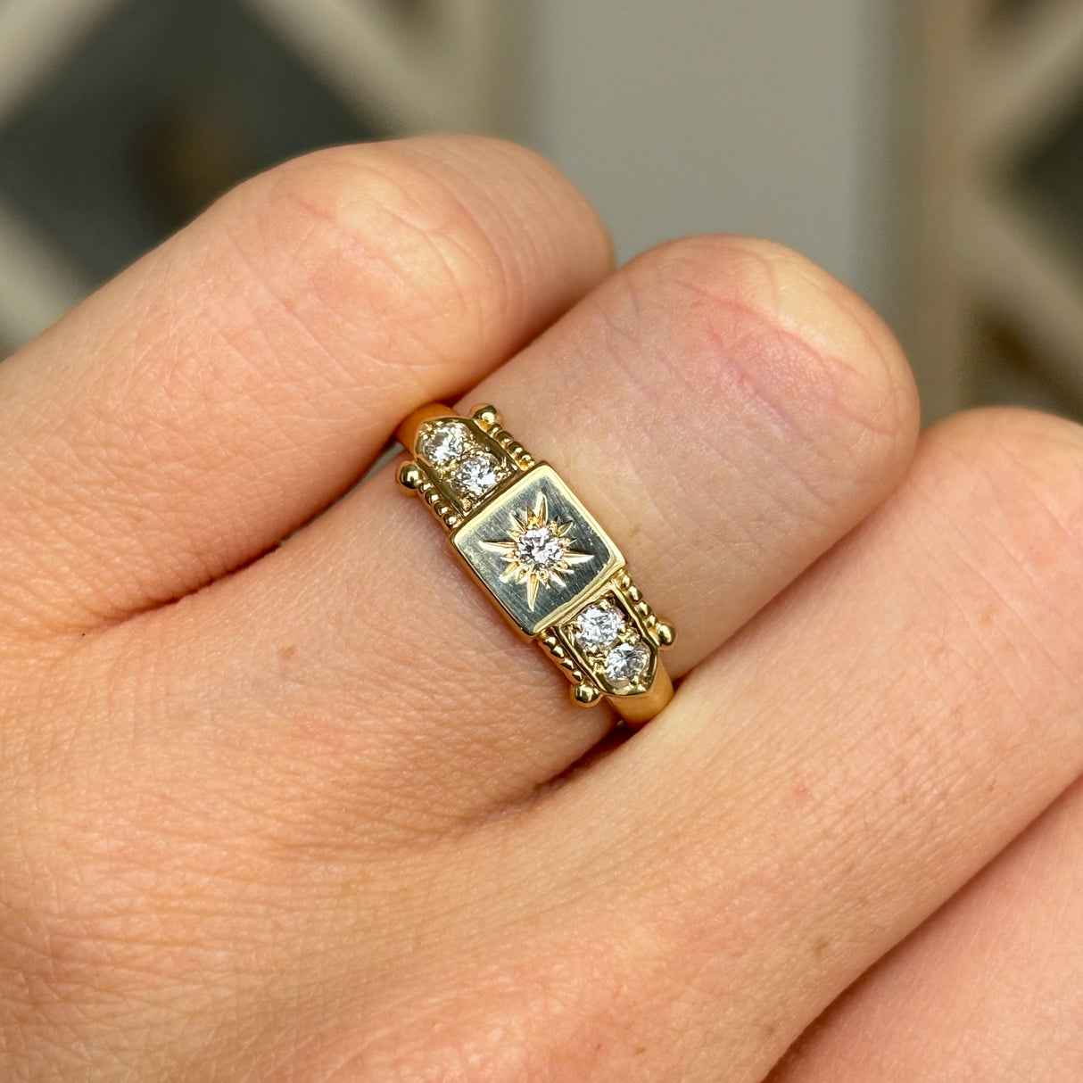 Vintage, 1990s five-stone diamond ring worn on hand