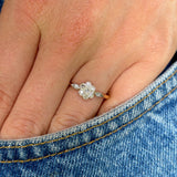 Antique, Edwardian diamond engagement ring worn on hand in pocket of jeans.