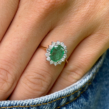 Vintage, 1990s emerald & diamond cluster ring worn on hand.