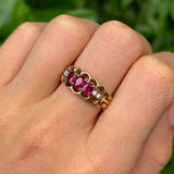 Vintage, 1980s ruby and diamond three-stone ring worn on hand.