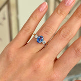 Vintage, 1950s sapphire & diamond three-stone ring worn on hand.