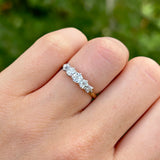 Antique, Edwardian five-stone diamond ring back worn on hand.