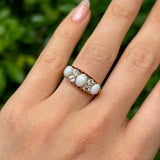 Victorian, opal & diamond three-stone ring worn on hand.