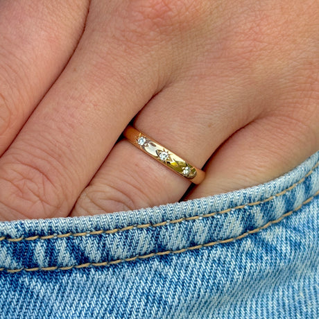 Vintage, 1960s three-stone diamond band worn on hand.