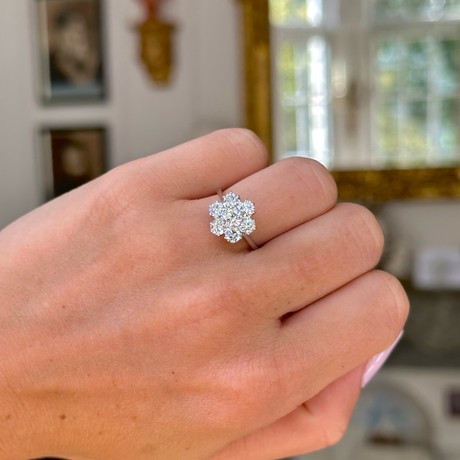 vintage diamond cluster ring, worn on closed hand.