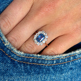 Antique, Edwardian blue & white sapphire cluster ring worn on hand.