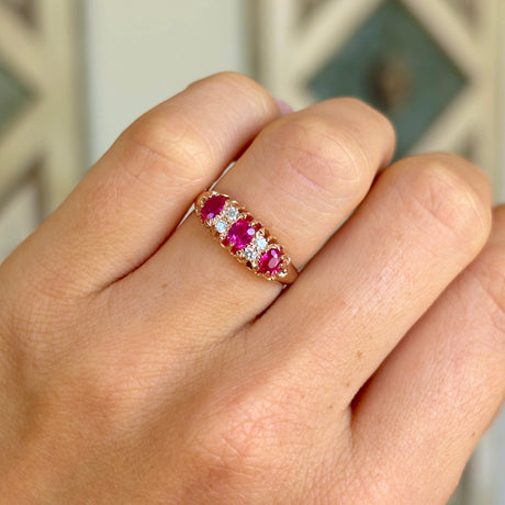 Antique, Victorian pinky-red ruby & diamond half-hoop ring worn on hand