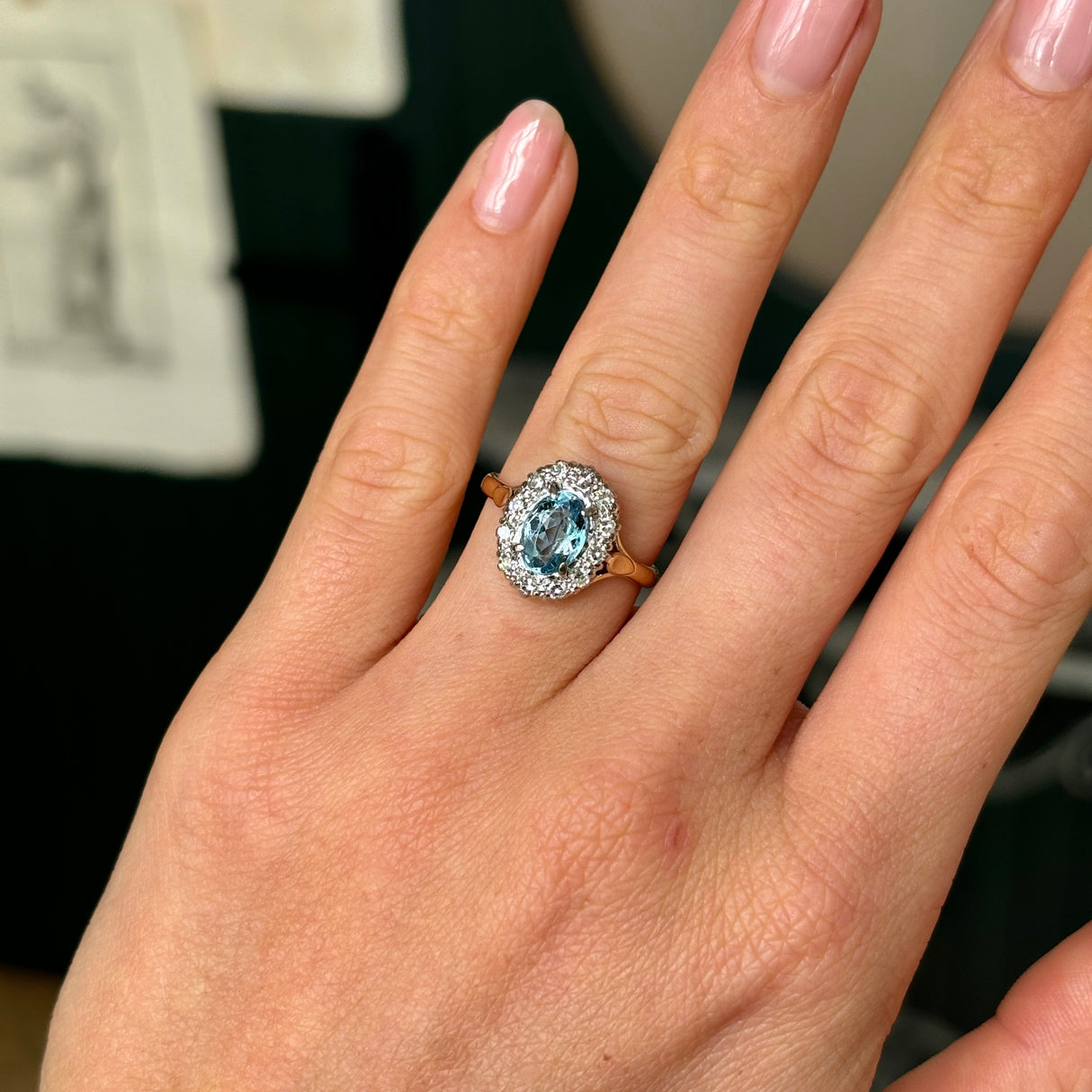 Antique, Edwardian blue topaz & diamond cluster ring worn on hand.