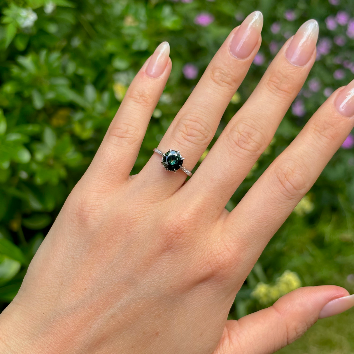 Antique, Edwardian teal sapphire & diamond ring, platinum worn on hand.