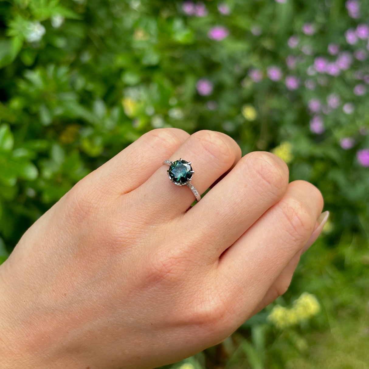 Antique, Edwardian teal sapphire & diamond ring, platinum worn on hand.