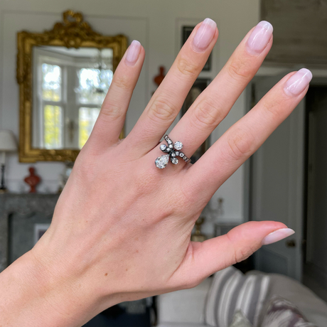 antique pear cut diamond ring, worn on hand.