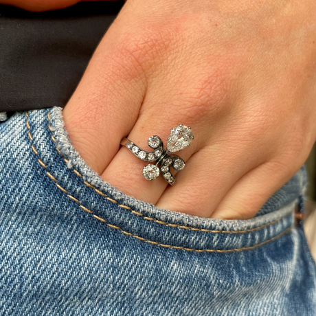 antique pear cut diamond ring, worn on hand.