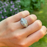 Antique, Belle Époque diamond bombé ring, platinum worn on hand.