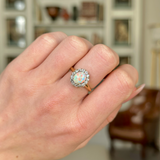 Antique, Edwardian White Opal and Diamond Cluster Ring worn on closed hand. 