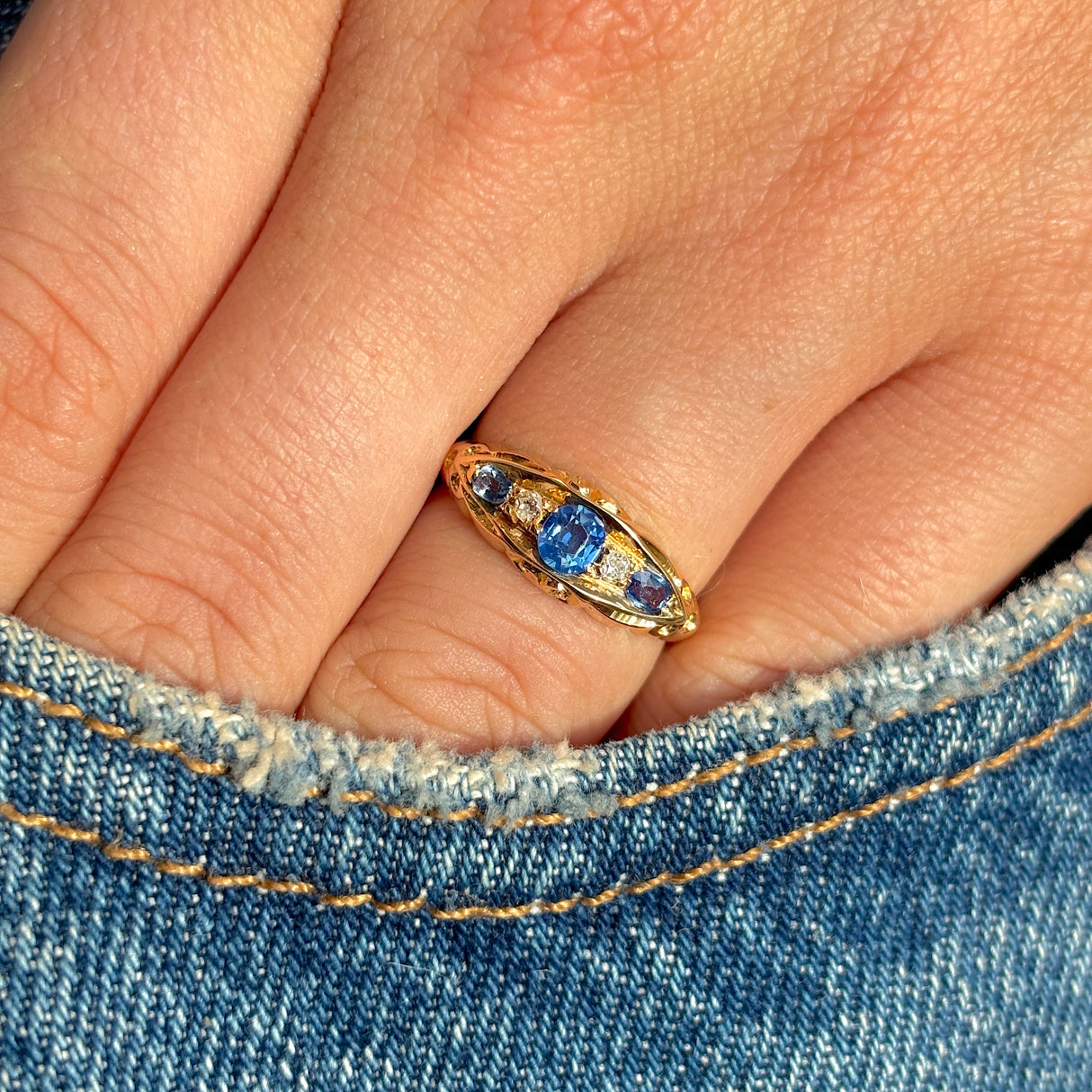 Antique, Edwardian sapphire & diamond five-stone ring worn on hand.