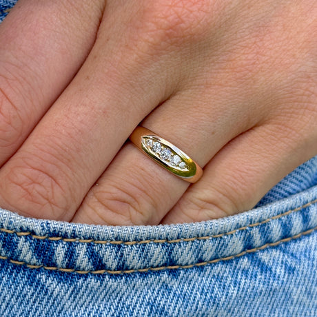 Antique, Edwardian five-stone diamond ring worn on hand
