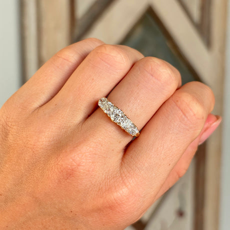 Antique, Edwardian five-stone diamond ring worn on hand