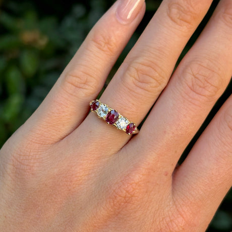 Antique, Victorian ruby & diamond five-stone ring worn on hand.