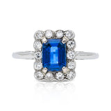 Antique, Art Deco, emerald-cut blue sapphire and diamond cluster ring, platinum