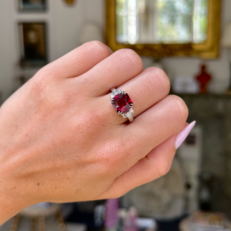 Vintage red garnet and diamond ring, worn on hand.