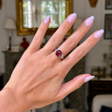 Vintage red garnet and diamond ring, worn on hand.