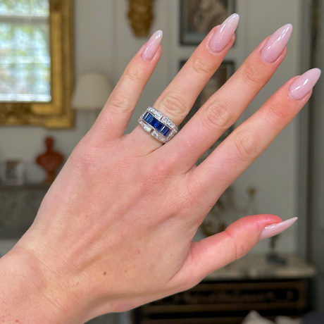 Sapphire and diamond Art Deco Band, worn on hand, front view. 