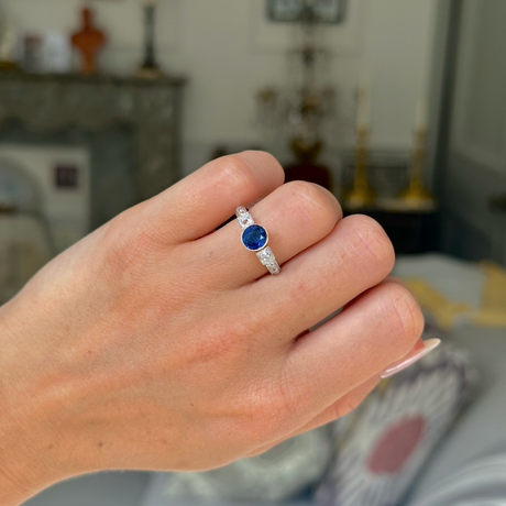 Art Deco sapphire and diamond engagement ring, worn on closed hand, front view. 