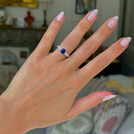 Art Deco sapphire and diamond engagement ring, worn on hand, front view. 