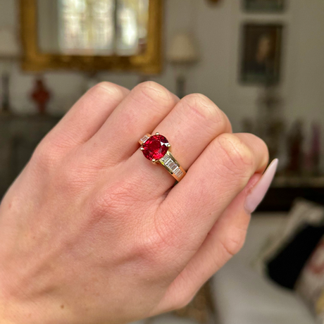 Art Deco spinel and diamond ring worn on closed hand. 