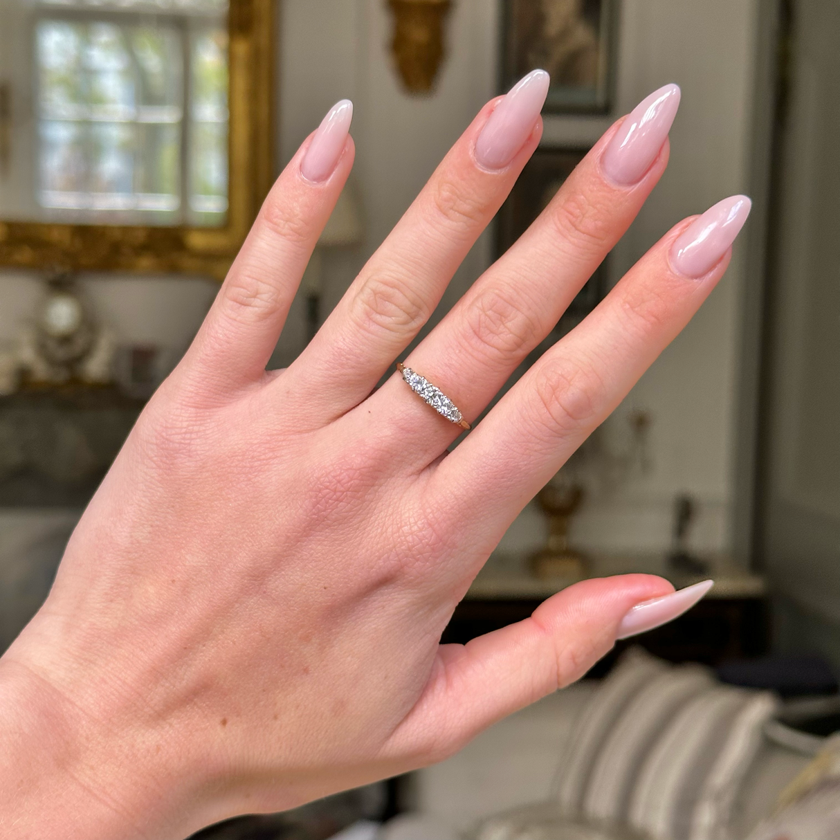 edwardian diamond half hoop ring on hand, front view. 