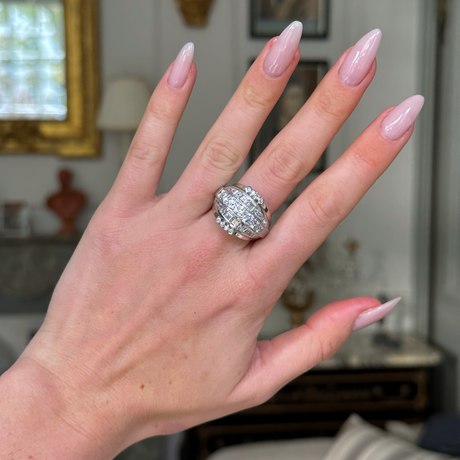 impressive Art Deco diamond bombe ring, worn on hand front view. 