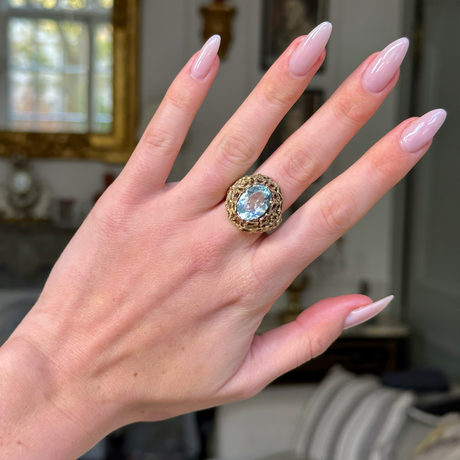 aquamarine ring with naturalistic textured yellow gold band on hand. 