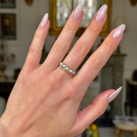 Georgian pearl half hoop ring worn on hand. 