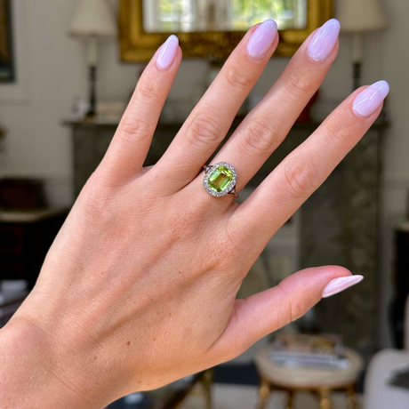 antique peridot and diamond ring, worn on hand, front view.