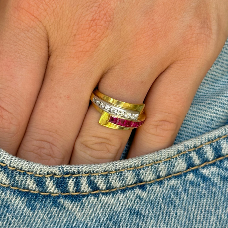 Retro Tiffany & Co. ruby and diamond ring worn on hand in pocket of jeans.