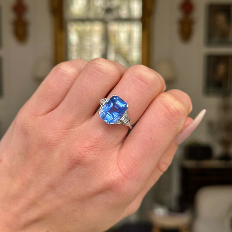 Art Deco sapphire and diamond ring worn on closed hand. 