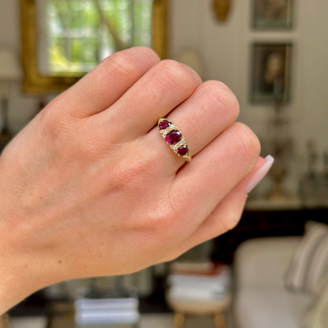 Antique Edwardian three stone ruby and diamond ring, worn on hand.