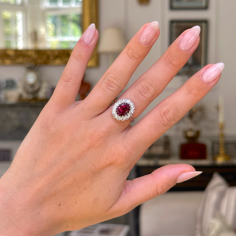 red tourmaline and diamond cluster ring, worn on hand,  front view. 