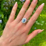 Vintage, 1980s cornflower blue sapphire & diamond cluster ring worn on hand.