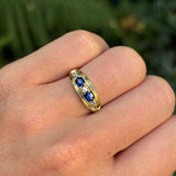 Vintage, Art Deco sapphire & diamond five-stone ring worn on hand.