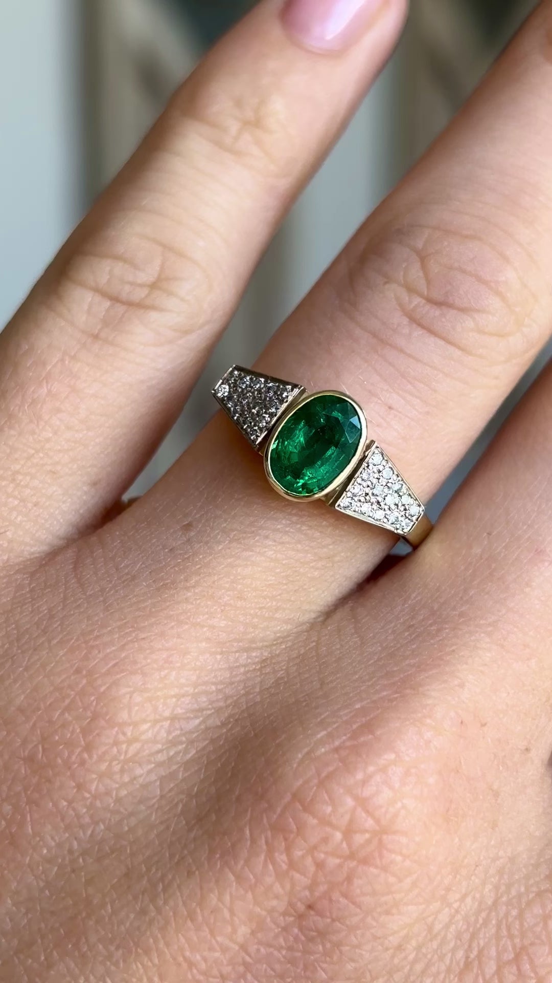 Vintage, 1970s inspired emerald & diamond ring worn on hand.