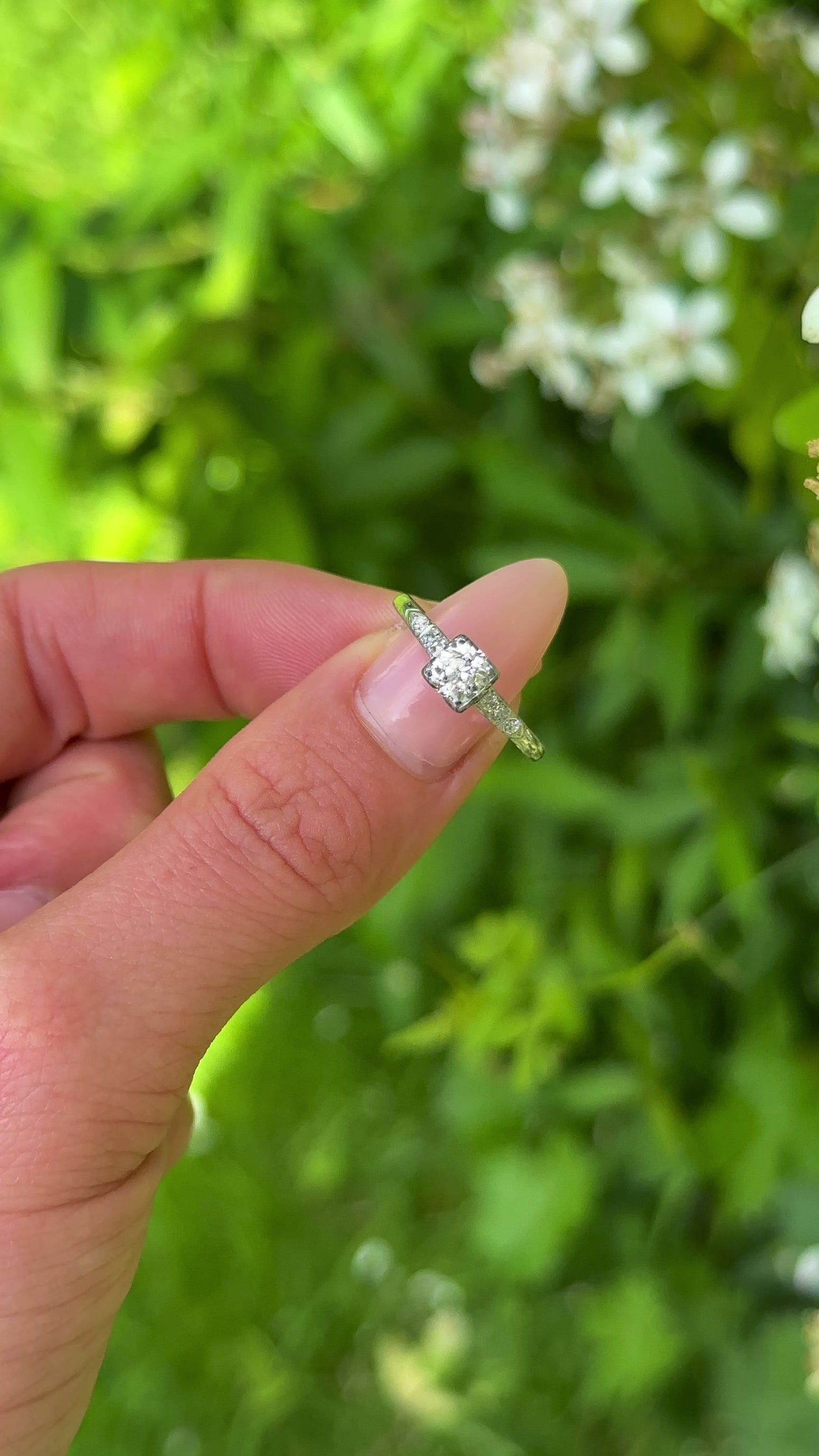 Vintage, 1940s Diamond Engagement Ring, White Gold and Platinum held in fingers.