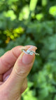 Antique, Edwardian Toi et Moi Diamond Engagement Ring, 18ct White Gold held in fingers.