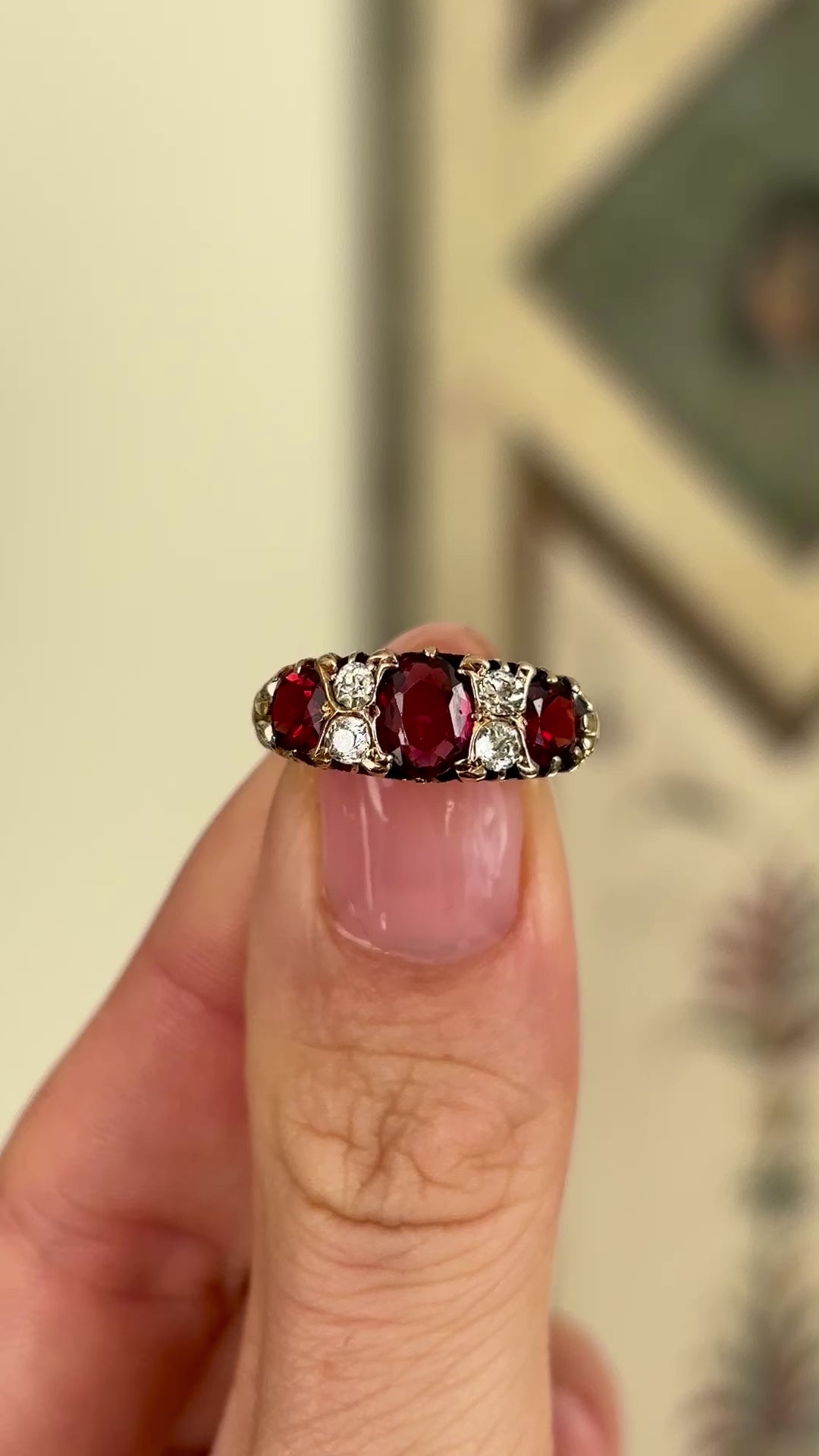 1952-Antique, Victorian garnet & diamond three-stone ring held in fingers.